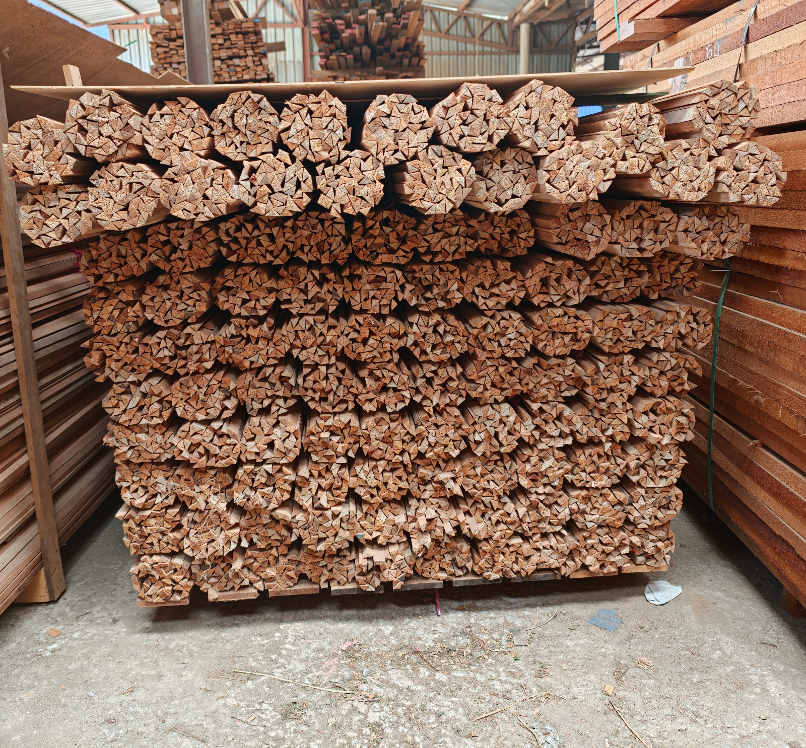 Pallet of bundled meranti beading in the warehouse alongside sawn timber racks