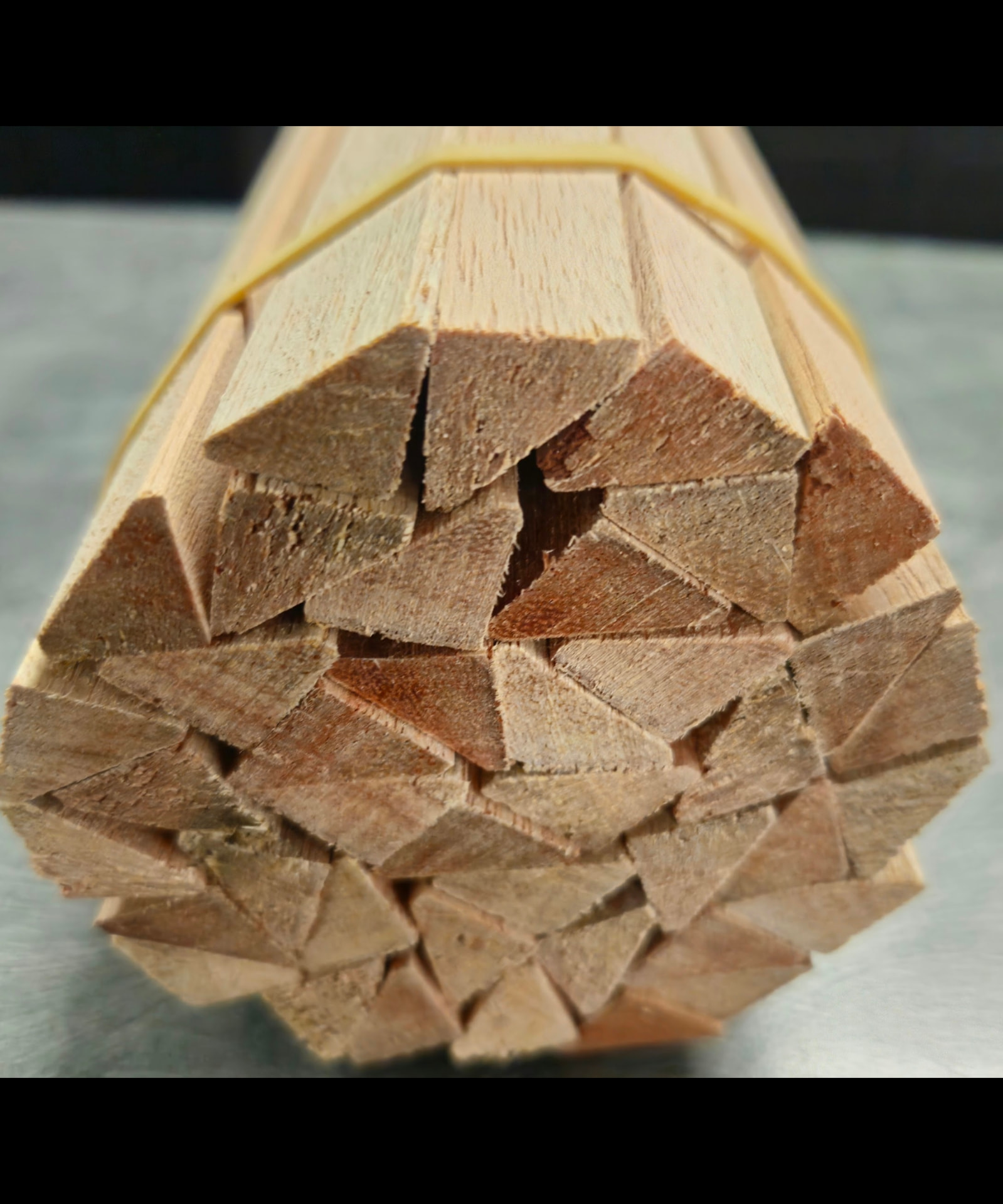 Bundle of meranti beading sticks strapped with an elastic band